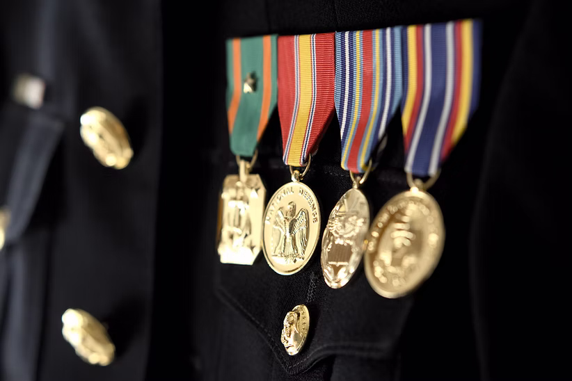 Military service medals pinned to a dark uniform